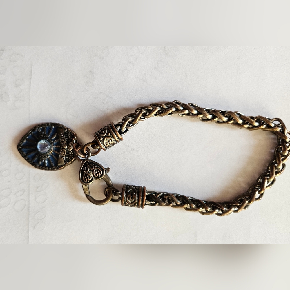 Bracelet with an enameled police badge.
